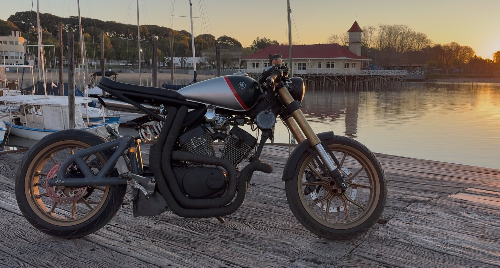 The finished Yamaha Virago cafe racer on the dock at sunset